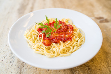 Delicious spaghetti pasta with tomato sauce and parsley, homemade healthy italian pasta on marble background, taste spaghetti
