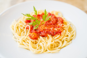 Delicious spaghetti pasta with tomato sauce and parsley, homemade healthy italian pasta on marble background, taste spaghetti