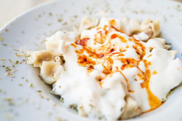 Turkish Mantı, traditional turkish food, sauce with yogurt on the turkish ravioli