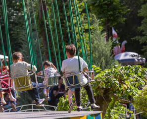 Fototapeta na wymiar a park. children playing in the carousel
