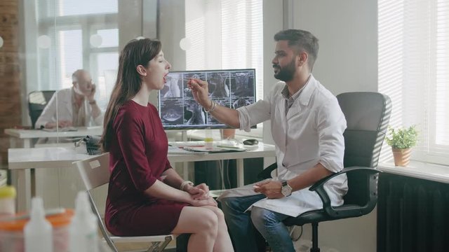 Taking saliva from mouth of woman for DNA analysis