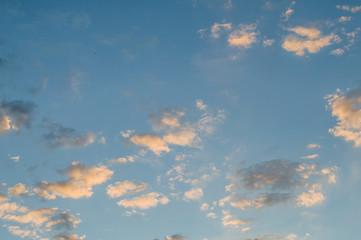 Beautiful blue sky with white clouds illuminated by the sun