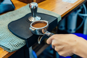 Close-up of making coffee. Close-up image of male barista preparing fresh coffee