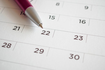 Calendar page with pen point at 22nd date