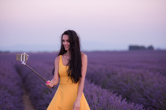 woman in lavender field taking selfie