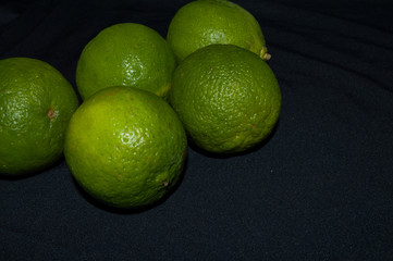 green lime tahiti, or taiti lemon or Citrus latifolia, isolated on black background