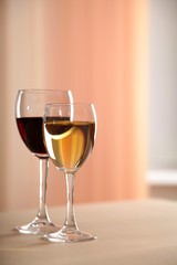 A glass of white wine and a glass of red wine