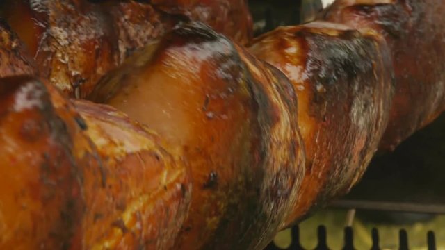 Delicious crispy meat turning on a skewer