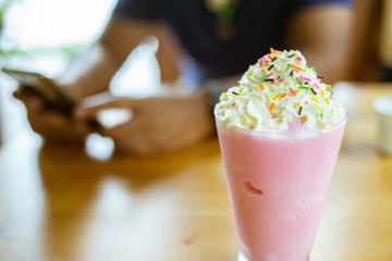Glasses of pink milk smoothies, milkshake or cocktail  on wooden background.Close up focus.