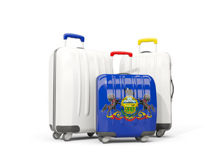 Luggage with flag of pennsylvania. Three bags with united states local flags