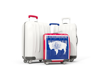 Luggage with flag of wyoming. Three bags with united states local flags