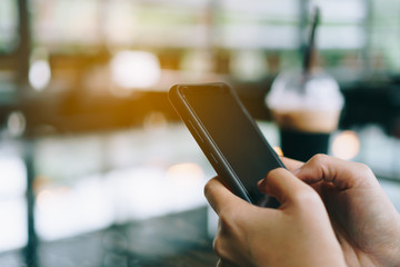 Woman hand using smartphone or tablet to do business, financial or trading stock forex market in park outdoor nature road background.