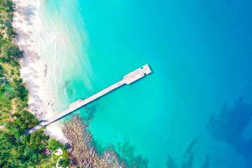 Blue turquoise water sea island with green tree summer vacation background © themorningglory