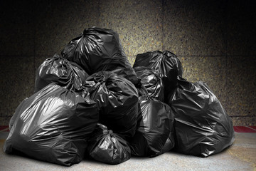 garbage is pile lots dump, many garbage plastic bags black waste at concrete wall, pollution from...