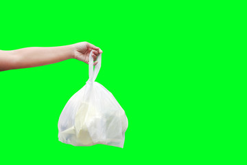 Hand is carrying waste plastic garbage bags isolated on green screen background, Hand holding plastic garbage bags for dump waste over green screen for presentation