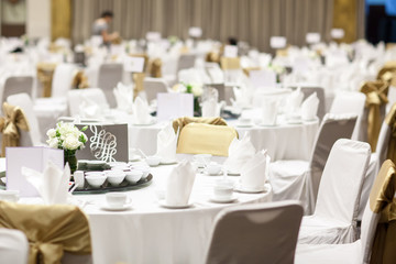wedding table sets in wedding hall. wedding decorate preparation. table set and another catered event dinner, luxury wedding table setting for fine dining at indoors.