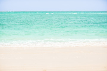 Soft wave of blue ocean on sandy beach. background. selective focus. beach and tropical sea white foam on beach. soft focus on bottom of picture.