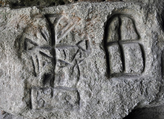 Ancient Germanic runes on the wall of the cave