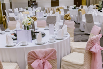 wedding table sets in wedding hall. wedding decorate preparation. table set and another catered event dinner, luxury wedding table setting for fine dining at indoors.