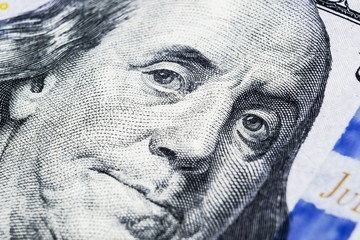 Close up view Portrait of Benjamin Franklin on the one hundred dollar bill. Background of the money. 100 dollar bill with Benjamin Franklin eyes macro shot.