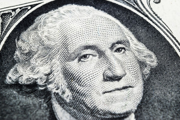 US president George Washington face portrait on the USA one dollar note. Macro shot. Background of the money. George Washington eyes macro shot.