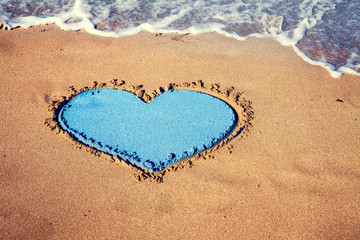 inscription heart on beach sand