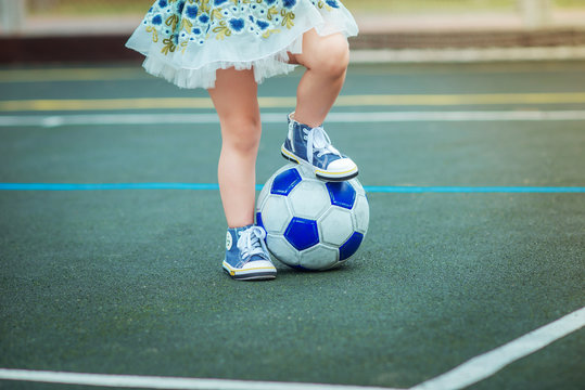 Close-up Of A Soccer Ball And Legs Of A Girl On A Soccer Field