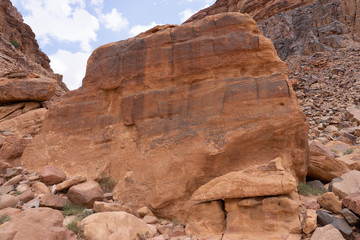 Rock with nabatean petroglyphs and inscriptions in Wadi Rum desert, Jordan