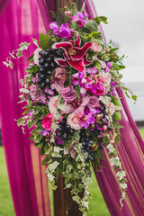 Wedding decorations Boho style with pink and purple orchids, roses, ivy and grape