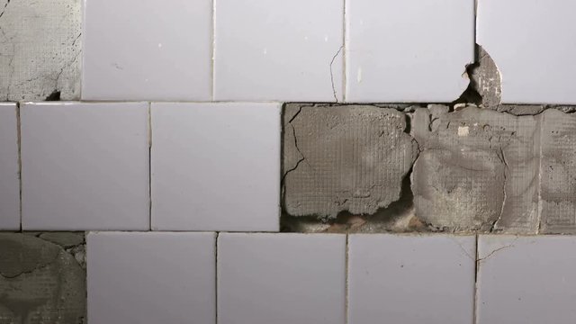 Old building interior some of tiles in the kitchen are falling off from the wall