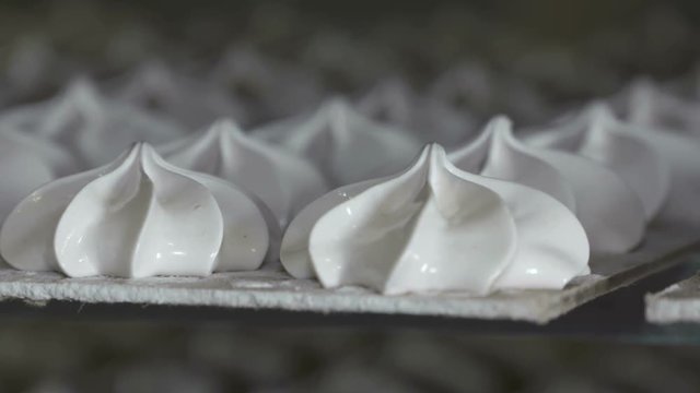 Cooling racks with finished marshmallow zephyr on trays at confectionery factory