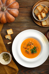 pumpkin soup in plate on wooden boards, food flat lay