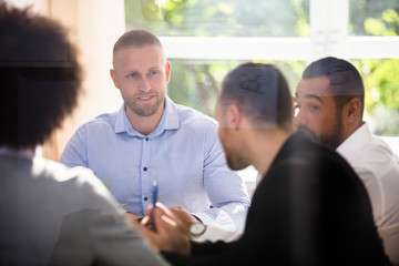 Group Of Businesspeople Sitting In Office