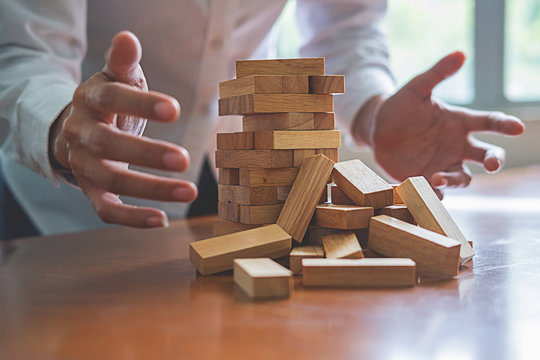 Problem Solving Business can't stop effect of dominoes continuous toppled with business team feeling sad and stress in office background. Failure Business Concept.