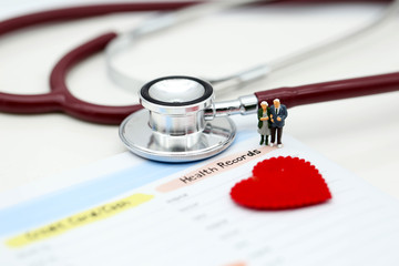 Miniature people : Doctor and patient Cardiogram with stethoscope and red heart,A heart beats graph...