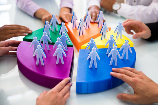 Businesspeople Joining Pieces Of Pie Chart With Human Figures