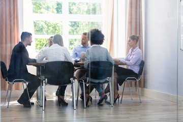 Group Of Businesspeople Sitting In Office