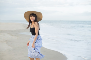 Beautiful girl smiling happily on a sunny day, Hua Hin beach, Thailand