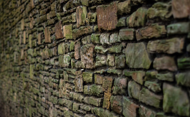 Ancient stone, brick wall with moss