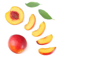 Nectarine with green leaf and slices isolated on white background. top view