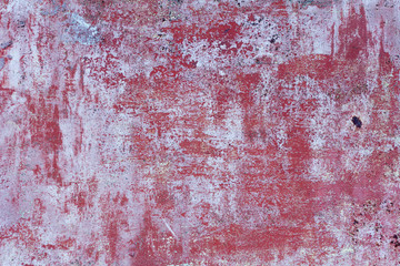 old metal wall with peeling paint and rust