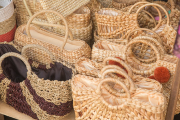 Straw bags on display. Different handcrafted woven or wicker bags