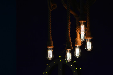 Lighting background. Light bulbs on a dark background.