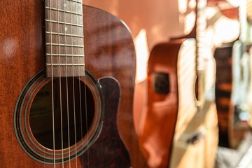 Fototapeta premium Three Guitars Standing in Shop - Close Up