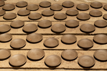 Clay plate placed on the wood to dry before the fire
