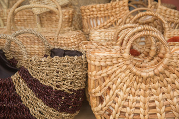 Obraz premium Straw bags on display. Different handcrafted woven or wicker bags