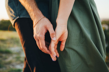 Hands of a young couple. Gentle touch, romantic moment. Close-up. - obrazy, fototapety, plakaty
