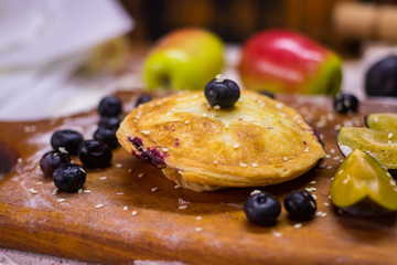 Sweet tart with blackberries, sesame seeds and fruits inside backed in oven. Vegan dessert, vegetarian healthy dietary food. Yummy crusty pie.