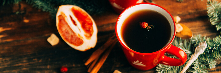 Christmas hot cranberry tea, cookies and light bokeh, closeup