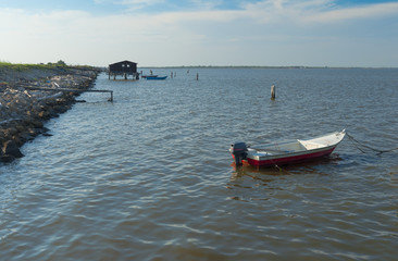 Mussel cultivation, boats at Scardovari lagoon, Po' river delta, Adriatic sea, Italy, UNESCO World Heritage Site.